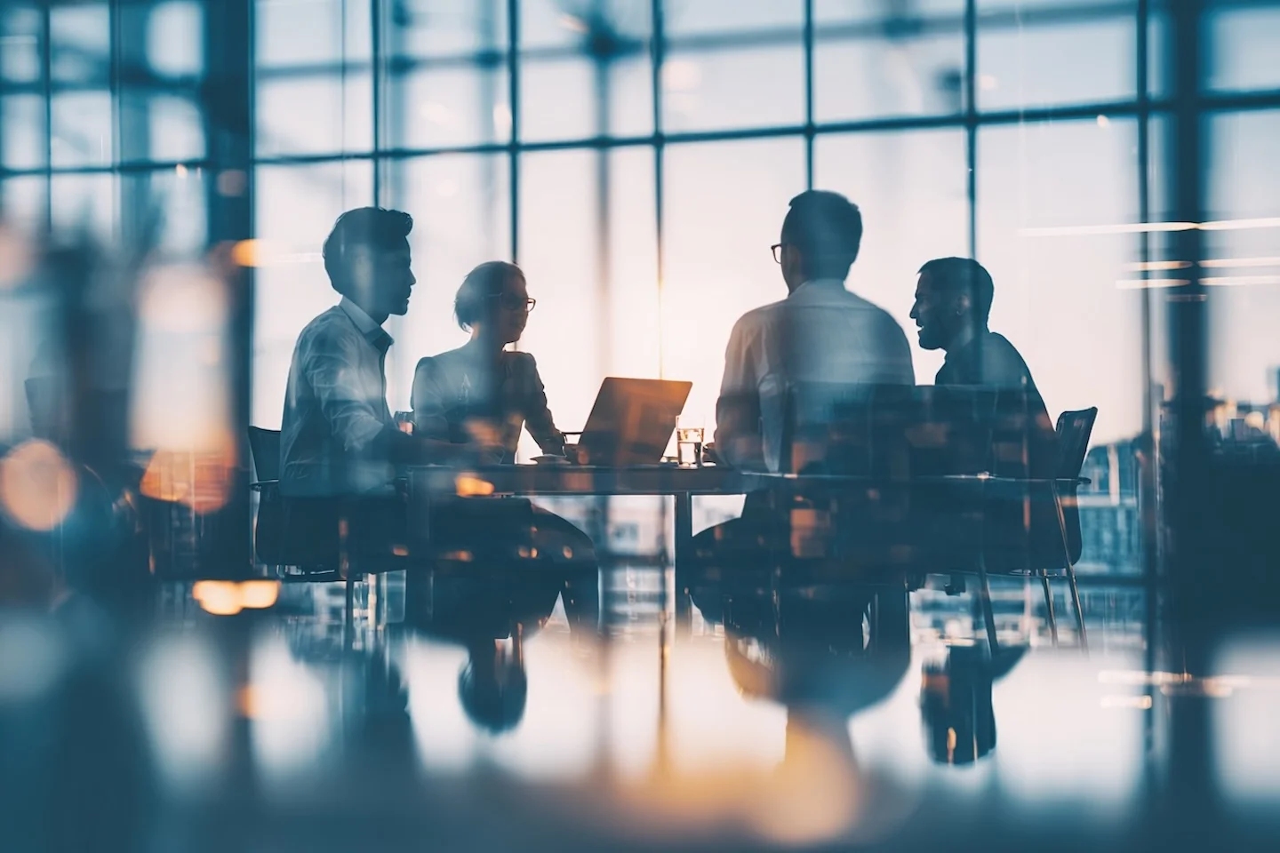 Silhouettes of executives in a glass boardroom deep in conversation at golden hour, reflecting the gap between AI adoption and real business impact